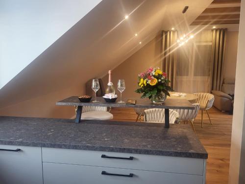 a kitchen with a table with flowers and wine glasses at Waldresidenz Lutz in Bad Lippspringe