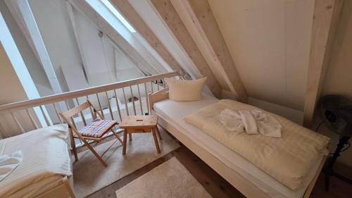a small room with a bed and a chair at Altstadt Loft in Waren