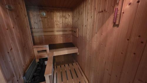 a wooden sauna with a bench in it at Altstadt Loft in Waren