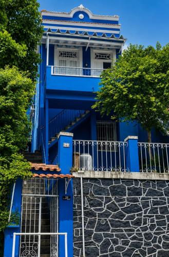 a blue building with a staircase in front at Panorama Inn in Rio de Janeiro