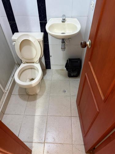 a bathroom with a toilet and a sink at Hotel Terranova SM in Santa Marta