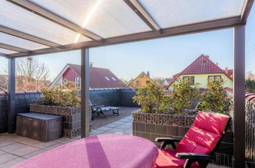 a patio with a table and a chair on a patio at Ferienwohnung Sonnendeck in Klink