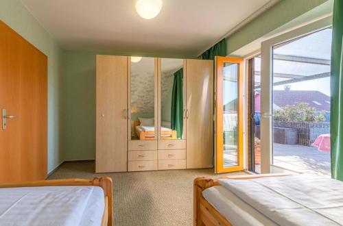 a bedroom with a bed and a sliding glass door at Ferienwohnung Sonnendeck in Klink