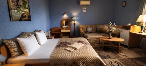 a bedroom with a bed and a living room at Old Town in Izmail