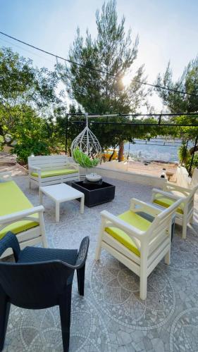 a group of chairs sitting on a patio near the beach at Mountain View House- بيت إطلالة الجبل in Ajloun