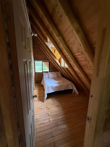 an attic room with a bed in the attic at Chalet Amar in Mazo