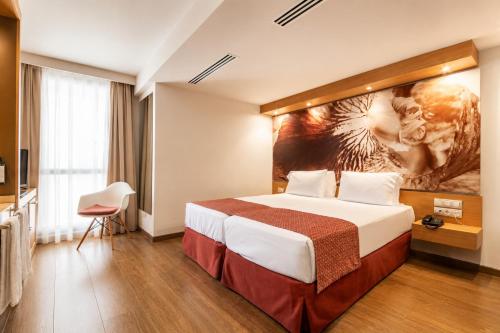 a hotel room with a bed and a painting on the wall at VM Princep in Andorra la Vella