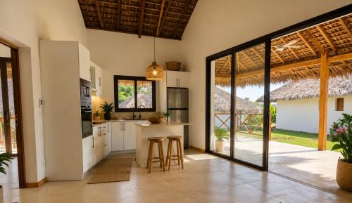 an open kitchen with a counter and stools at ITAMPOLO Suites & Lodges in Nosy Be