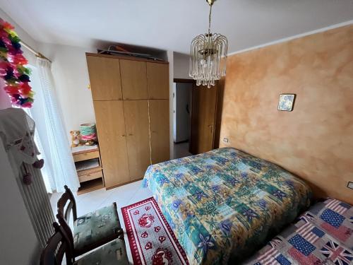 a bedroom with a bed and a chandelier at Casa Adry in Cles