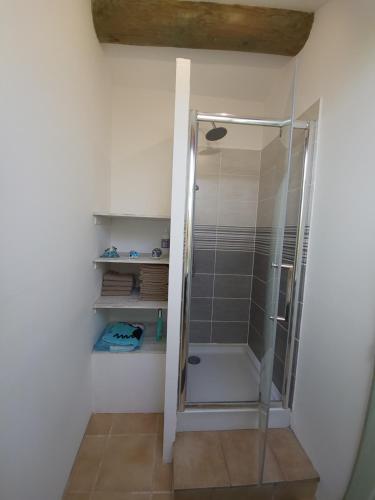 a shower with a glass door in a bathroom at Au 3 bis in Caderousse