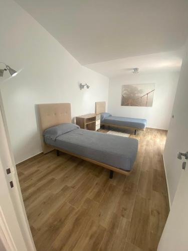 a room with two beds and a table in it at Marbella Sunseat apartment in Marbella