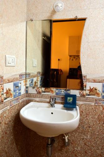 a bathroom with a sink and a large mirror at Serenity Casa ll in Varca