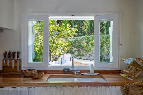 a kitchen with a sink and two windows at Villa Achilleas Crete in Ierapetra
