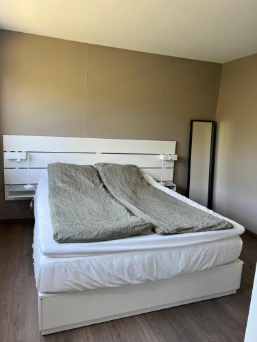 a bedroom with a bed with a white bed frame at Bright apartment in Haslum in Haslum 