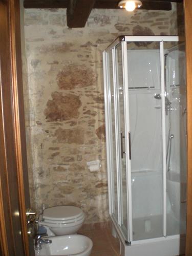 a bathroom with a toilet and a walk in shower at House Morro di Rasiglia in Rasiglia