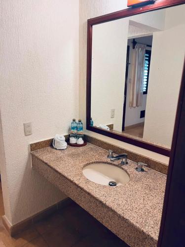 a bathroom with a sink and a large mirror at Villas Chicanna Calakmul in Chicanna