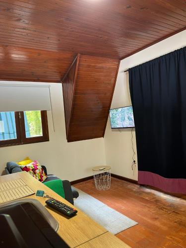 an office with a desk and a table and a window at Bungalow Refúgio do Pezo T0 in Melgaço