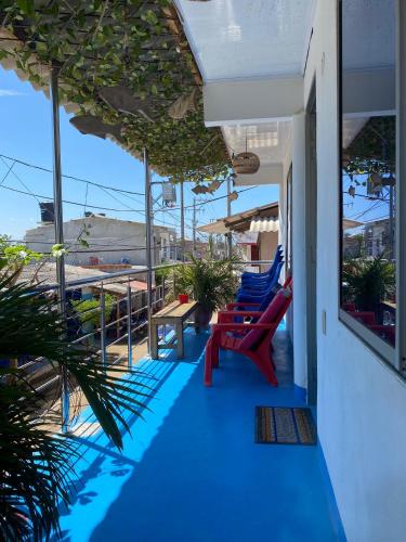 a porch with chairs and a table on a balcony at Ramos de mar in Rincón