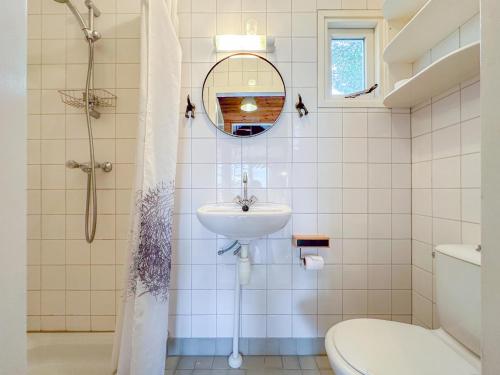 a bathroom with a sink and a toilet and a mirror at Bleu Dream in Ellemeet