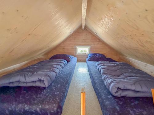 a room with three beds in a attic at Bleu Dream in Ellemeet
