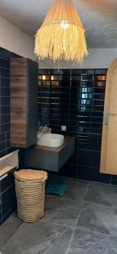 a bathroom with a sink and a chandelier at Espectacular dúplex a pie de mar in Cabo Negro