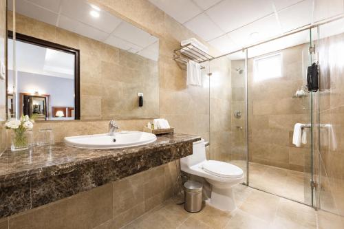 a bathroom with a sink and a toilet and a shower at G8 Diamond Hotel Saigon in Ho Chi Minh City