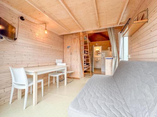 a room with a bed and a table and chairs at Sea Foam in Ellemeet