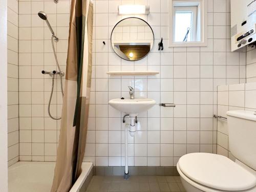 a bathroom with a sink and a toilet and a mirror at Sea Foam in Ellemeet