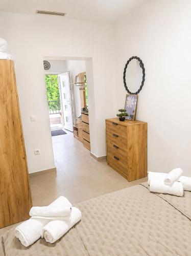 a bedroom with two towels on a bed and a dresser at Christina in Otok