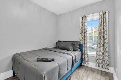 a bedroom with a bed and a window at 5-Bed Home Game Room Pool Table Sleeps 13 in Buffalo