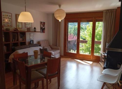 a living room with a bed and a table and a couch at Pis Relapieso in Vilaller