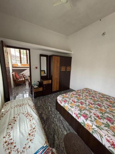 a hotel room with a bed and a window at Sai Srushti Homes in Gonikoppal