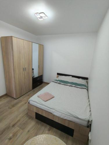 a small bedroom with a bed and a cabinet at Intime Poto House Suceava in Suceava