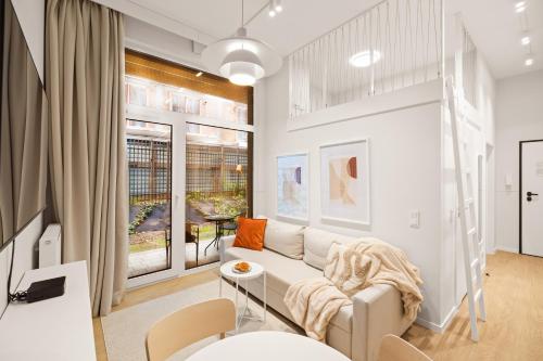 a living room with a couch and a table at City Break Śląska 8 by INA in Gdańsk