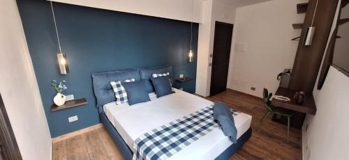 a blue bedroom with a bed with blue walls at Luana in Caltagirone