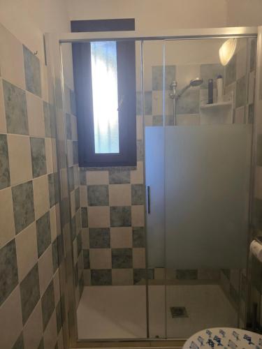 a shower with a glass door in a bathroom at Holiday Sun in Badesi