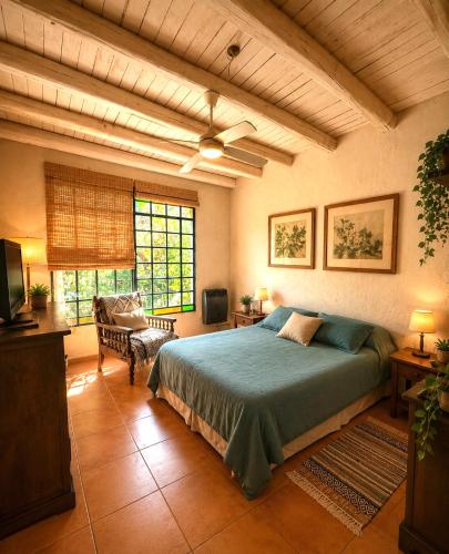 a bedroom with a bed and a television in it at Las Pircas, casa de campo in Ciudad Lujan de Cuyo