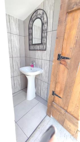 a bathroom with a white sink and a mirror at Villa Aura, Kanalia Corfu in Corfu