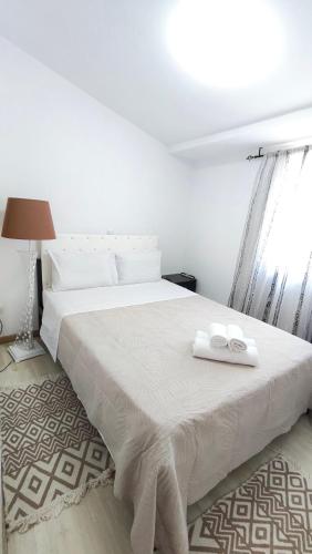 a bedroom with a white bed with two towels on it at Villa Aura, Kanalia Corfu in Corfu