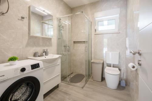 a bathroom with a shower and a toilet and a sink at Villa Nature in Čapljina