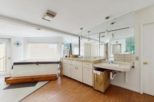 a bathroom with two sinks and a large window at Poolside Oasis! Phoenix Group Sanctuary w/ Patio in Phoenix