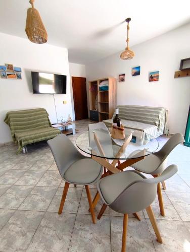 a living room with a glass table and chairs at A & K Vacation House in Város