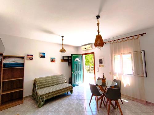 a living room with a table and a green door at A & K Vacation House in Város