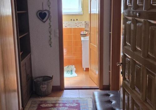 a bathroom with a door open to a bathroom with a sink at Una Mirage in Bihać