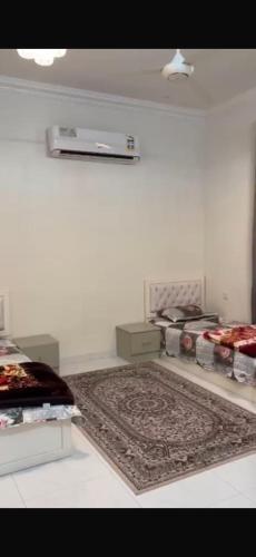 a white room with a rug on the floor at Sea Breeze Ras Al Hadd in Sur