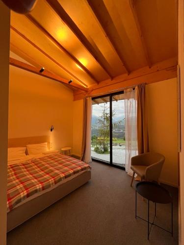 a bedroom with a bed and a large window at Amper Villa Dilijan in Dilijan