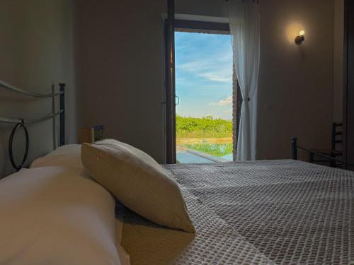 a bedroom with a bed with a view of a window at Podere Tre Berte - The Sleeping Beauty in Acquaviva