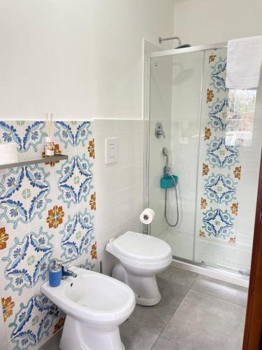 a bathroom with a toilet and a shower and a sink at B&B Sunset da carla in Agropoli