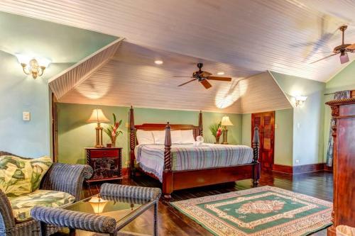 a bedroom with a bed and a ceiling fan at Toucan Suite @ Mahogany Hall in San Ignacio