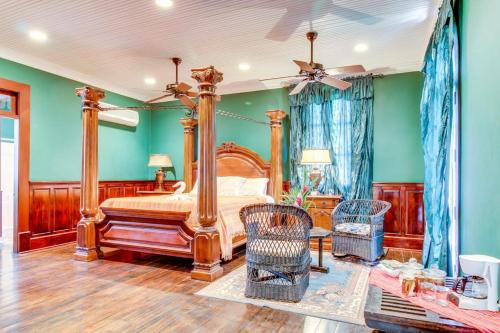 a bedroom with a canopy bed and green walls at Colonial Suite @ Mahogany Hall in San Ignacio